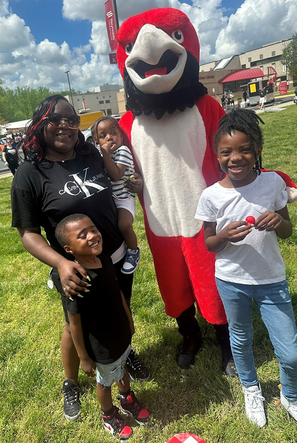 Teunshea Morris and grand children, pose at a festival with Sarge, the Reynolds mascot