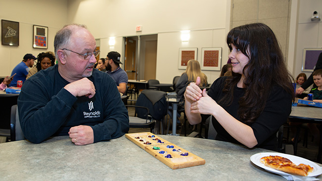 A man and woman having fun playing a board game.