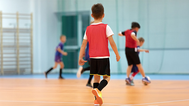 Image of a child enjoying a game of indoor soccer.